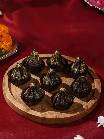 A perfect platter of my chocolate modaks, dusted with edible gold for a touch of festive glamour.