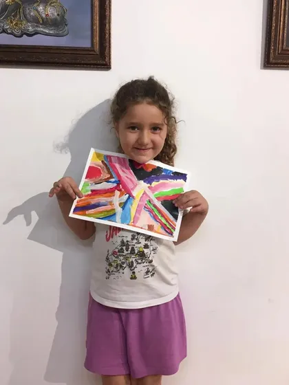 A duplicate image of a young artist showing off her fantastic abstract expressionist painting.