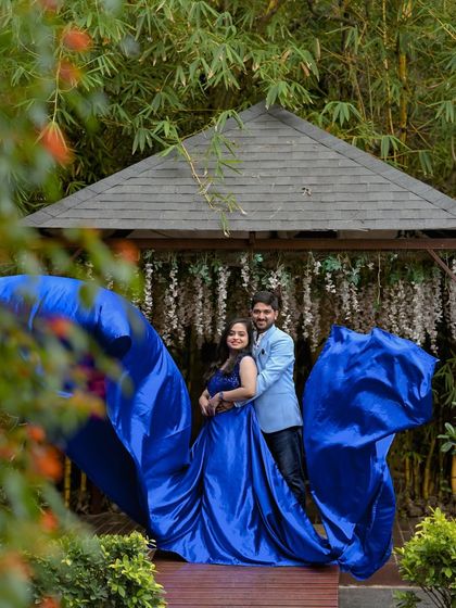 A creative shot of a flowing blue gown against the backdrop of our garden gazebo.