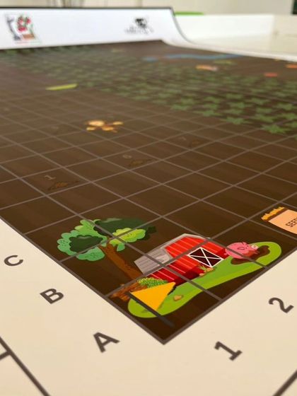 A first look at the challenge mat for the IRO Robo Adventures Explorers category. We guide our youngest competitors, aged 5-7, to program robots for tasks like sowing seeds and harvesting fruit.
