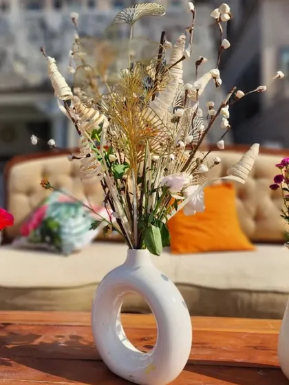 A rustic and modern centerpiece using dried flowers and pampas grass in a unique ceramic vase.