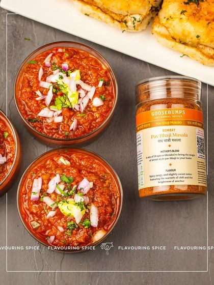 A perfect serving of Bombay Pav Bhaji, topped with fresh onions and a dollop of butter, ready to be enjoyed. My masala blend sitting alongside is a promise of the authentic, flavourful experience you can create at home.