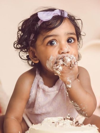 This little diva is enjoying her first taste of cake. We focus on capturing their expressions, from curiosity to pure delight.