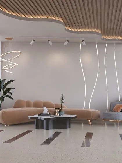 This lounge area uses a mix of curved and straight lines to create visual interest. The combination of a plush sofa, a structured armchair, and minimalist lighting results in a balanced and contemporary commercial space.