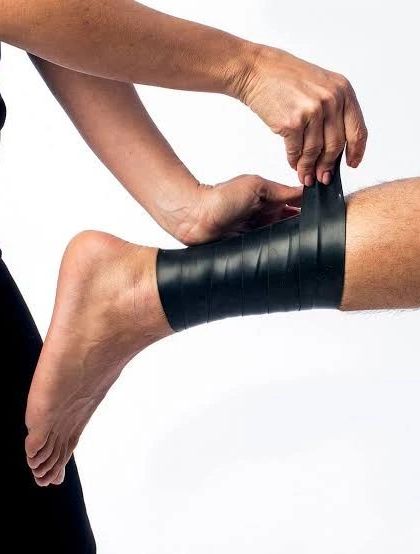 Fascia Flossing, shown here being applied to an ankle, is one of the quickest and safest ways to achieve pain relief. This technique works by compressing the fascia to improve joint range of motion.