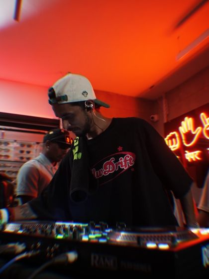 Another angle from the Slw Drift party, showing me focused on the mix. The red neon lights set the perfect mood for the night.