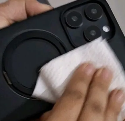 A close-up of a team member cleaning a phone case before the shoot, ensuring a perfect, fingerprint-free shot.