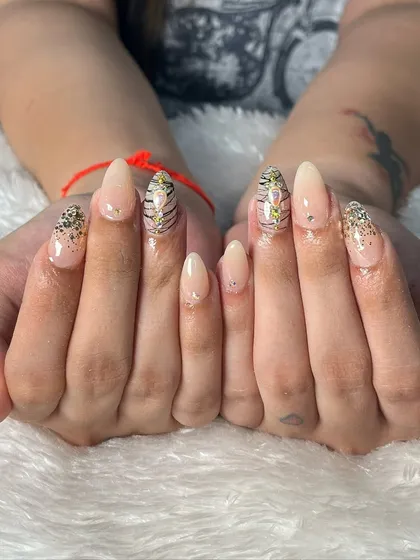 Another beautiful example of our bridal nail services. This client opted for elegant almond-shaped extensions with a subtle nude base, accented with glitter and a touch of animal print for a modern and chic look.