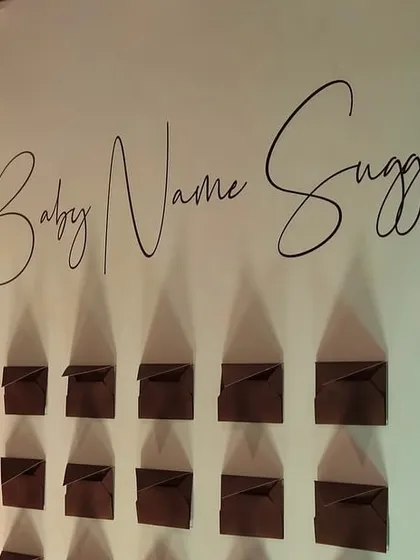 An interactive 'Baby Name Suggestions' wall is a wonderful way to engage guests. We designed this elegant display with custom calligraphy to fit the baby shower's sophisticated theme.
