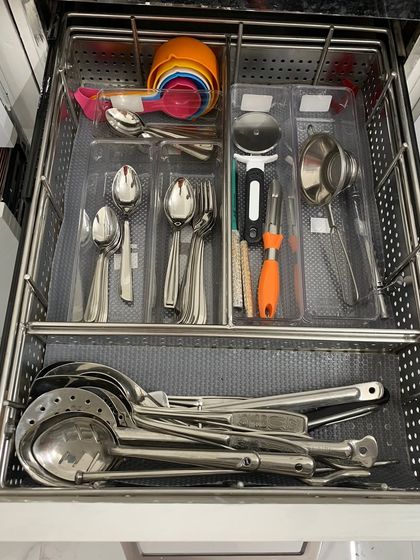 A drawer system for a busy kitchen. The top section holds everyday cutlery and gadgets, while the bottom is for larger serving spoons and ladles.