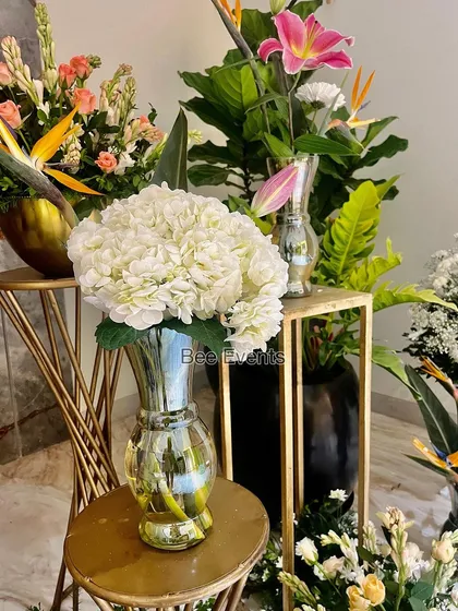 A close-up of a modern floral arrangement in a silver vase. We focus on teaching the small details that elevate a simple flower setup into a piece of art.