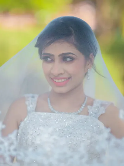A dreamy shot through the veil. The makeup is soft and romantic, creating a beautiful and ethereal effect.