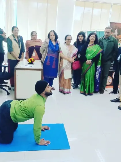 I was invited to lead a yoga therapy session at NTPC, where we focused on poses to counteract the effects of long hours spent sitting at a desk. Here, I'm demonstrating the Cat-Cow stretch, a simple yet effective movement for improving spinal flexibility and relieving back tension for corporate employees.
