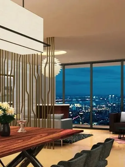 This visualization captures the evening ambiance of a high-rise condominium. The design incorporates a dramatic wooden dining table and a decorative screen, creating an elegant space for entertaining against a sparkling city backdrop.