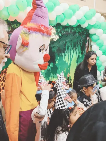 The Joker mascot making sure the cake cutting is a fun and lively moment.