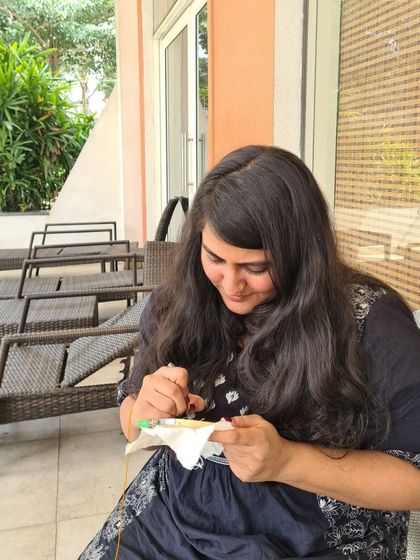 A student smiling as she works on her piece. My workshops are designed to be a happy escape where you can focus on creativity and enjoy the process.