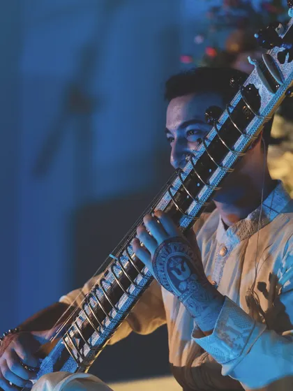 A close-up shot from my New York show, capturing the joy and connection I feel while playing. The henna on my hands, with its Shiva-inspired symbols, is an important part of my pre-show ritual.