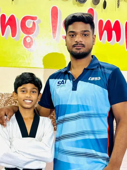 With my student, a future black belt. The bond between a coach and a student is built on trust, respect, and shared goals.