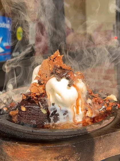 A scoop of ice cream melting on my hot Sizzling Brownie. It's the perfect combination of hot and cold.