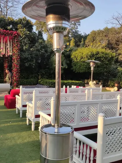 Guest comfort is a top priority, especially for outdoor events in Delhi NCR's cooler months. I provide practical solutions like these tall patio heaters to ensure attendees stay warm and comfortable throughout the event.