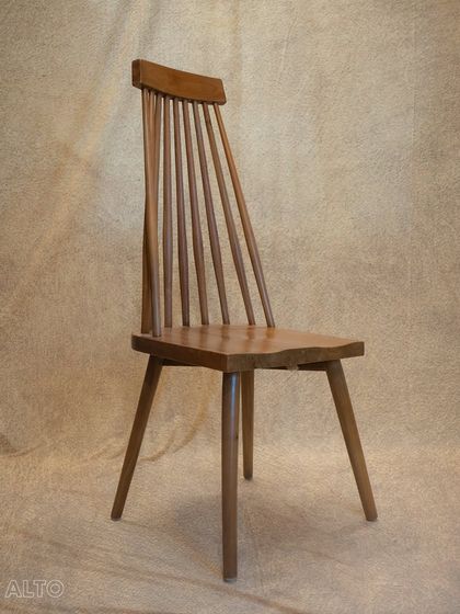 A full view of the 'Alto' dining chair. Its high back and sturdy construction make it a comfortable and durable choice for everyday use.