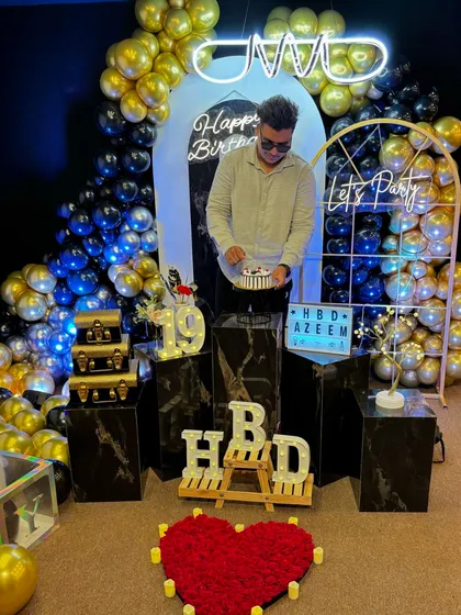 The full birthday setup in all its glory. This image shows the complete decor, including a heart made of roses, "HBD" light-up letters, and a stunning balloon arrangement, ready for an epic 19th birthday party.