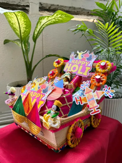 Another angle of our premium Holi hamper, showing off the festive decorations and the variety of items packed inside. It's a gift that truly captures the spirit of Holi.