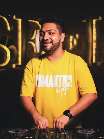A happy moment behind the decks. The warm lighting and my smile capture the positive and fun atmosphere of my club nights.