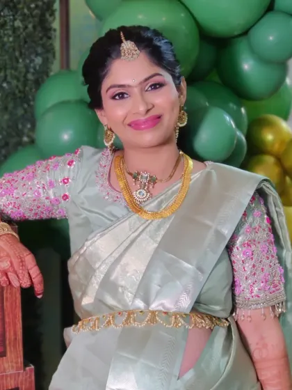 Keerthana posing by the cute decor at her baby shower. The makeup is soft and pretty, perfect for a daytime celebration.