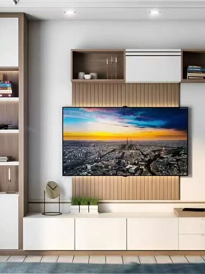 This TV unit design focuses on clean lines and balanced storage. We combined white and wood-finish cabinets, including a bookshelf and overhead storage, with a central fluted panel behind the TV for a touch of texture.