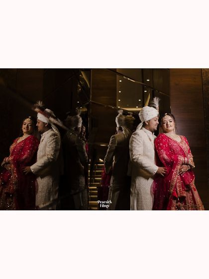 A creative portrait of the couple, their reflection captured in a mirrored wall, creating an artistic and elegant image of their union.