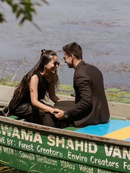 A close-up, candid shot of the couple sharing a smile in the boat. This image focuses on their happy and relaxed interaction during their serene pre-wedding shoot.