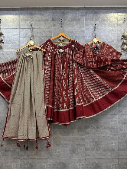 A beautiful maroon and beige set with traditional Ajrak print. This outfit has a classic, earthy feel and is perfect for an elegant Navratri look.