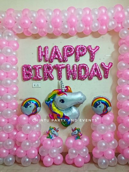 A simple and sweet unicorn theme birthday decoration. This setup uses a pink and white balloon frame and a large unicorn head foil balloon.