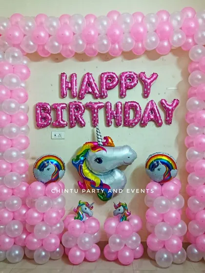 A simple and sweet unicorn theme birthday decoration. This setup uses a pink and white balloon frame and a large unicorn head foil balloon.
