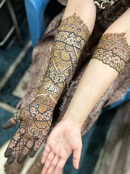 One arm features the full bridal design while the other has a complementary armband, a popular choice for modern brides. This was for the lovely bride Tasmiya.