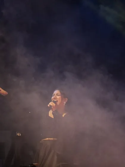 A dramatic shot of me on stage, surrounded by theatrical smoke. Creating a larger than life atmosphere is part of the magic of a Sangeet night.