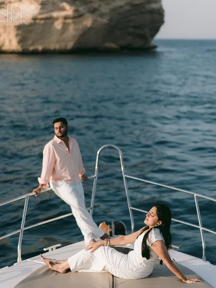 A beautiful composition on a yacht in Oman, capturing a moment of serene relaxation against the backdrop of the sea and coastal rocks.