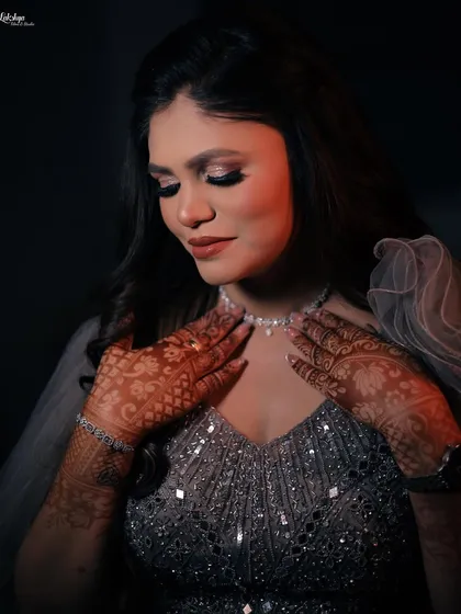A close-up portrait focusing on the bride's beautiful makeup and henna-adorned hands. These details are an essential part of the bridal story.