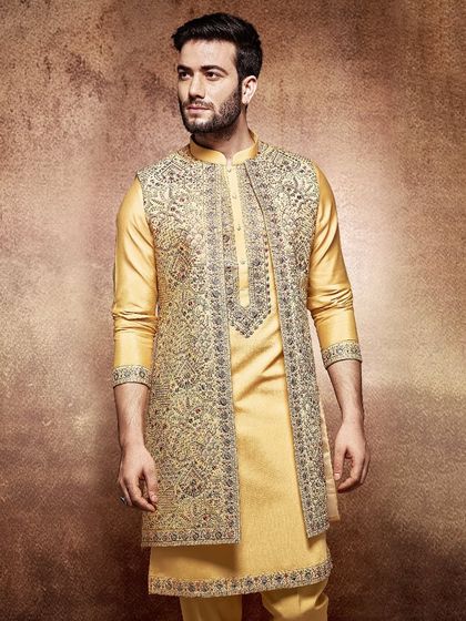 Golden hues for a golden day. This bright yellow kurta is paired with a magnificent, heavily embroidered jacket, creating a look that is both celebratory and regal.