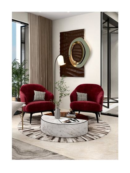 When working with a neutral palette, we introduce one or two bold colored pieces to create visual interest. Here, a pair of red chairs acts as a focal point without overwhelming the calm vibe.