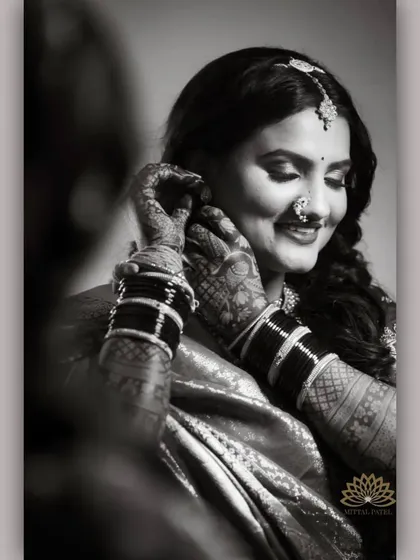 A beautiful black and white portrait of a bride. The monochrome effect highlights the intricate patterns of the mehndi, showing its beauty beyond color.