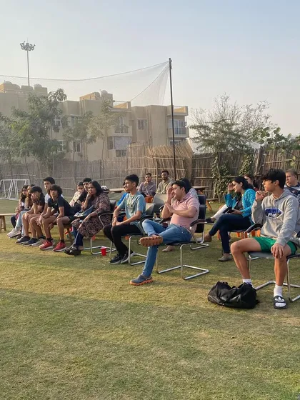 A nutrition session held on the grass, with both athletes and parents in attendance. We believe in educating our entire community.
