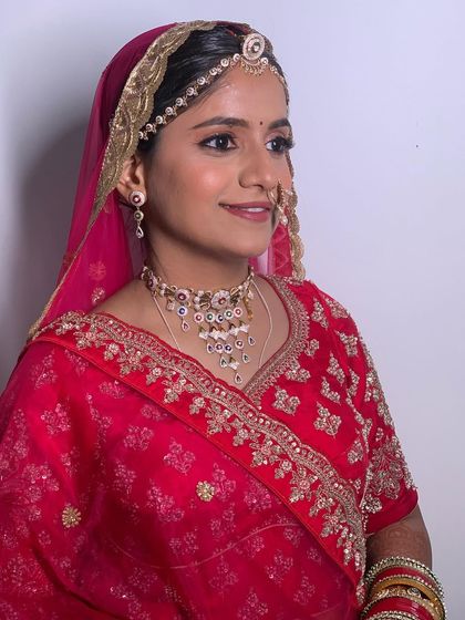 A side profile showing the traditional Rajasthani draping and jewelry, including the borla maang tikka and nath.