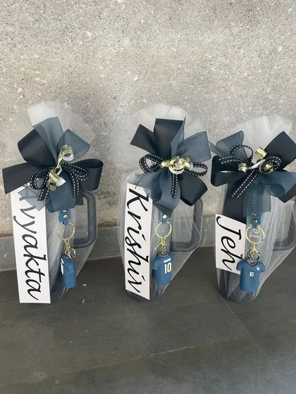 Personalized mugs wrapped and ready to be gifted as return favors. Each mug is customized with a name and a themed keychain, making it a fun and practical gift for kids' birthday parties.