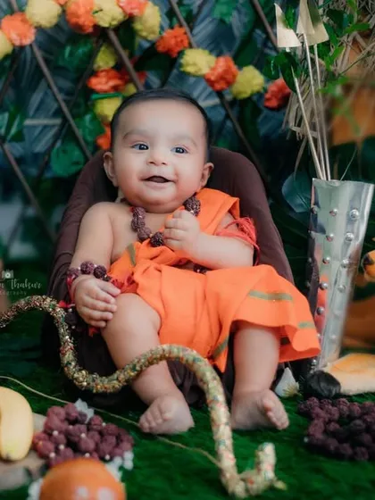 Surrounded by fruits and flowers in his little forest setup, this baby Ram is the picture of divine happiness.