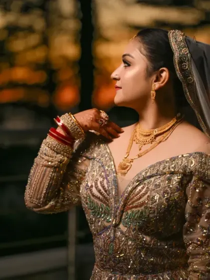 A profile portrait of the bride at dusk, highlighting the elegant silhouette of her gown and the warm colors of the sunset.