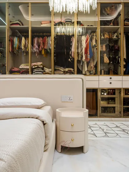 This angle shows the seamless connection between the bedroom and the open walk-in closet. The custom bedside table and the elegant wardrobe design create a cohesive and luxurious master suite.