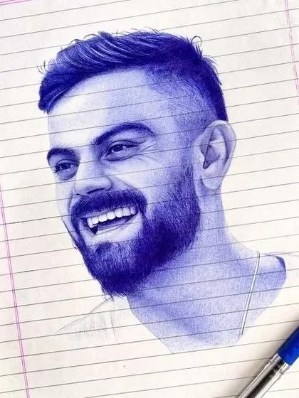 A unique portrait of cricketer Virat Kohli drawn entirely with a blue ballpoint pen. This technique requires precise control to build up layers of ink for shading, capturing his joyful expression on a simple sheet of lined paper.