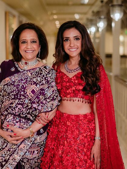 Coordinating looks for a mother and daughter. For the mother, I chose a sophisticated palette with a soft smokey eye that paired beautifully with her deep purple sari, while her daughter wore a vibrant red lehenga.